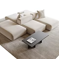 Beige Modular Sofa And Black Coffee Table Set With Cushions On Light Rug