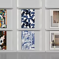 Abstract Paintings Displayed on White Shelves in Two Rows with Various Colorful Designs