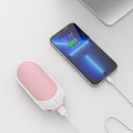 Smartphone Charging With Pink Power Bank And Digital Accessories On White Surface