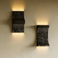 Modern Dark Metal Wall Sconces Mounted on Wall with Warm Glowing Light