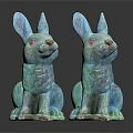 Two Turquoise Decorative Sitting Rabbit Statues on Dark Reflective Surface