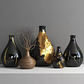 Black Gold And Textured Brown Ceramic Vessels With Gold Accents And Dried Branches