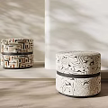 Patterned Cylindrical Stools Featuring Geometric And Abstract Designs In Indoor Space