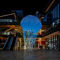 Large Blue Inflatable Jellyfish With Illuminated Tentacles In Nighttime Commercial Plaza