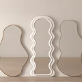 Three Different Shaped Mirrors With White And Wooden Frames Against Wall