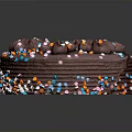 Delicious Layered Chocolate Cake With Chocolate Decorations And Colorful Sprinkles