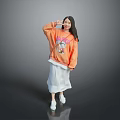 Woman In Orange Sweatshirt With Cartoon Graphic White Skirt Making Heart Gesture On Gray Background