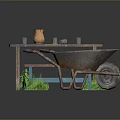 Outdoor Wooden Table With Clay Vase Glass Cups Red Bench And Rusty Wheelbarrow On Grass