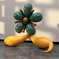 Flower Shaped Public Chair With Green Spotted Petals Orange Center And Yellow Seats