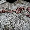 Rusty Metal Chain Scattered On Weathered Stone Ground Surface With Rough Texture 3d model