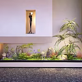 Minimalist Indoor Landscape With Lush Green Plants Decorative Rocks And Black Sculpture In Niche