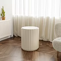 White Cylindrical Pleated Side Table on Wooden Floor with White Curtains and Natural Light