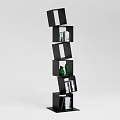 Black Modern Bookshelf With Irregular Compartments Featuring Books And Green Decorative Bottle