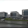 Multiple Modern Office Buildings With Glass Curtain Walls Green Lawn Pedestrians And Sunset Sky
