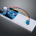 Blue Electronic Circuit Board With White Breadboard Connecting Wires And Components