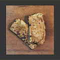 Delicious Grilled Flatbread Slices with Golden Brown Crust on a Wooden Cutting Board Platter