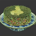Chocolate Cake With Golden Cream Topping And Colorful Sprinkles On Blue And White Plate