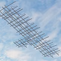 Interconnected Metal Pipes Forming Grid Pattern Against Blue Sky With White Clouds 3d model