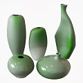 Elegant Green Ceramic Vessels in Various Shapes with Gradient Color and Textured Surface