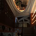 Elegant Restaurant Interior With Arched Ceiling Mural Brick Walls Staircase Chandeliers And Decorative Paintings