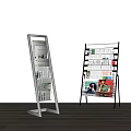 White and Black Metal Display Racks with Newspapers and Magazines on Multiple Layers