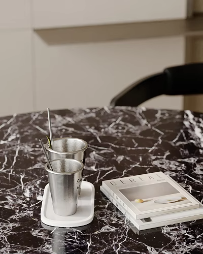 Decorative Ornament Set With Silver Cups Straws And Book On Marble Tabletop 3d model