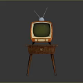 Vintage Orange Television With Antenna And Green Screen On Wooden Table
