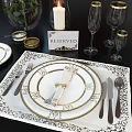 Elegant Tableware Combination with Gold Trimmed Plates Utensils White Roses Candles Glassware on Black Tablecloth