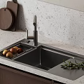 Kitchen Sink Area With Modern Faucet Stone Countertop Wooden Cutting Board Fruits And Olive Branch