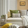 Cozy Couch Pillows in Green Black White Stripes and Geometric Patterns on Beige Sofa