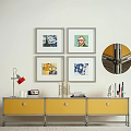 Yellow TV Stand with Red Desk Lamp Books and Four Framed Wall Artworks
