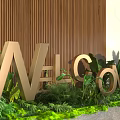 Golden Welcome Sign With Green Plants Decorating Modern Entrance Against Wooden Wall
