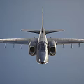 Metallic Gray Fighter Jet With Green Tail Flying In Pink Sky With Clouds