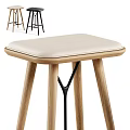 Two Modern Stools With Light And Dark Upholstered Seats And Wooden Legs