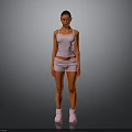 A Woman Standing in White Tank Top Shorts and White Boots Against Gray Background