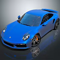 Blue Sports Car Featuring Streamlined Design And Shiny Alloy Wheels On Reflective Surface