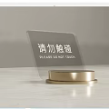 Transparent Acrylic Sign With Golden Base Displaying Please Do Not Touch Text