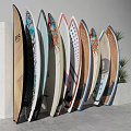 Vibrant Recreational Surfing Equipment with Colorful Patterns Flag Designs Arranged Against Wall with Plants