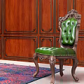Elegant Green Velvet Single Sofa in Room with Wooden Paneled Walls and Colorful Rug