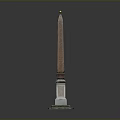 Tall Brown Obelisk Structure With White Stone Pedestal And Golden Top Decoration