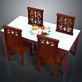 Wooden Dining Table With Four Carved Decorative Chairs And White Tabletop With Food Plates