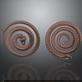 Copper Colored Coiled Snakes With Reflective Surfaces As Decorative Art Pieces