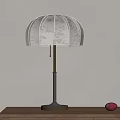 Elegant Table Lamp With Patterned Linen Shade And Brass Black Stand On Wooden Table