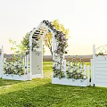 Garden Landscape Featuring White Picket Fence Arched Gate Flowers And Green Grass
