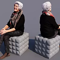 Smiling Woman Sitting On Textured Cube Stool Wearing Headscarf And Black Outfit