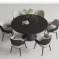 Round Black Dining Table Set with Six Gray White Chairs Green Plant Magazine and Vase