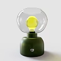 Modern Table Lamp With Green Base Transparent Spherical Shade Yellow Bulb And Silver Button 3d model