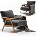 Stylish Gray Velvet Armchair With Wooden Armrests And Black White Striped Blanket Fringe