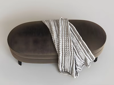 Dark Brown Oval Upholstered Ottoman With Light Gray White Striped Knitted Blanket 3d model