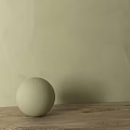 Light Green Sphere Placed On Wooden Tabletop Against Light Green Wall